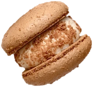 A JP Macarons macaron: two thick shells around a generous cream filling topped with biscuit crumbs
